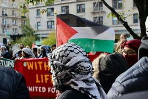 Pro-Palestinian protester wearing a keffiyeh outside of Columbia University 