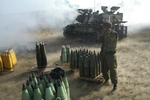 Israeli soldiers fires a shell toward a Hezbollah target in south Lebanon
