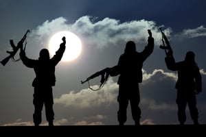  Silhouette of military soldier or officer with weapons at sunset