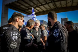 Demonstrates protest against the detention of Israeli reserve soldiers, at the Sde Teiman military base