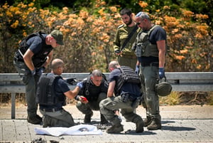 Israeli security forces at the scene where a drone fired from Lebanon hit the northern Israeli city of Nahariya, August 6, 2024.