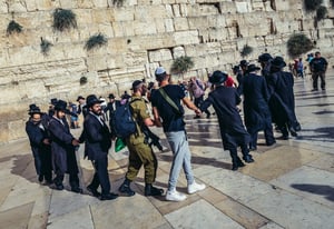 Orthodox Jews dance with Israeli soldiers next to the Kotel in the Old City of Jerusalem