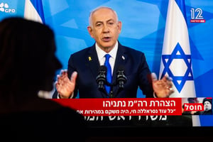 A woman watch a press conference of Israeli Prime Minister Benjamin Netanyahu at her home in Jerusalem, September 28, 2024