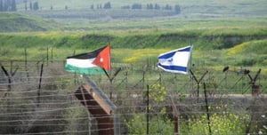 Flags on the border between Jordan and Israel