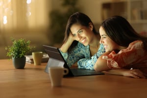 Two women watching on a tablet