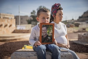 4- year old Lavi Shamir stands by the grave of his father Mordechai Shamir together with his mother. Shamir was killed on 7/10/2023