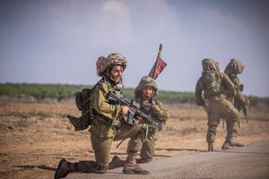 Israeli soldiers from the Netzah Yehuda Battalion patrol near the Israeli-Gaza border