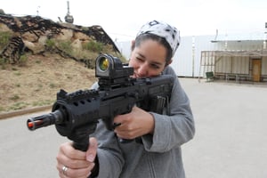 Settler woman from Efrat learning how to use the Mini Tavor Automatic Rifle