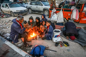 Displaced Palestinians crowd near the Netzarim corridor waiting for the road to be opened to return to their destroyed homes in the northern Gaza Strip as part of the ceasefire agreement between Israel and Hamas. January 26, 2025