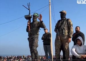 WATCH: Armed Hamas terrorists welcome those returning to the north