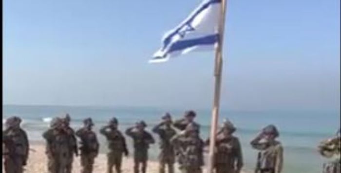 Waving the flag and singing the anthem in Gaza.