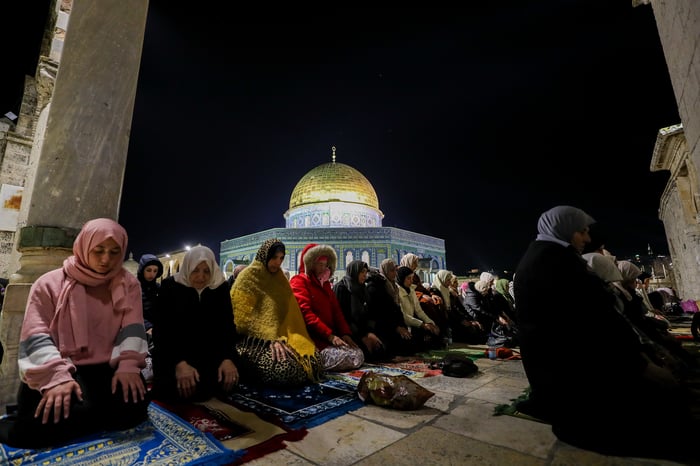 Palestinian worshippers perform Taraweeh prayers at the beginning of the holy fasting month of Ramadan, at the al-Aqsa mosque in Jerusalem's Old City, March 22, 2023. 