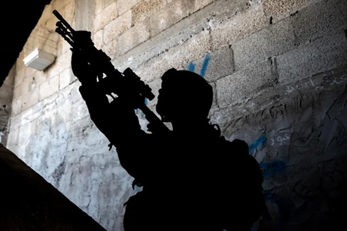 IDF soldier sweeping building in Khan Yunis.