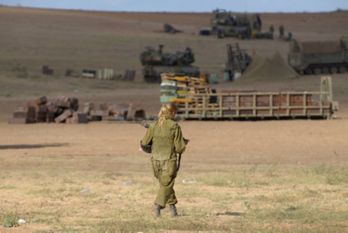 An Israeli female soldier is seen in an army deployment area near Israel-Gaza border. 