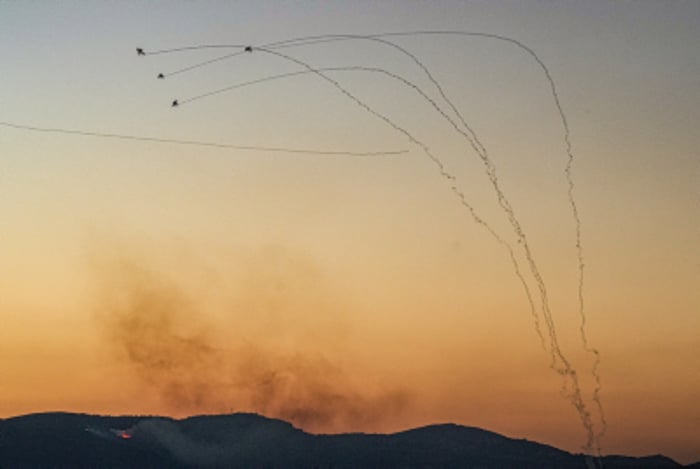 An anti-missile system fires interception missiles as rockets fired from Lebanon, seen from Kiryat Shmona, July 16, 2024