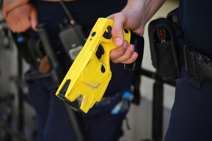 Police officers holding taser