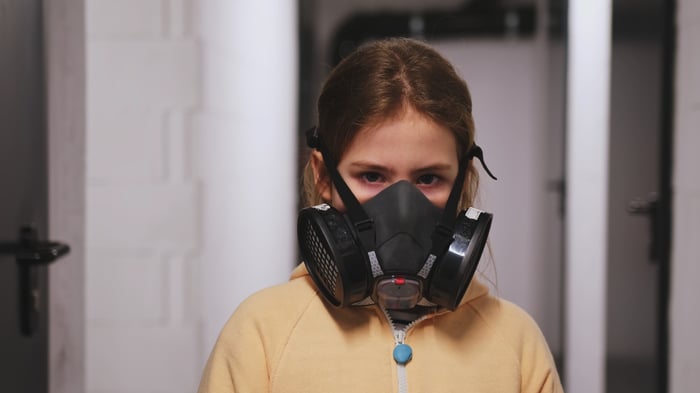 Girl wearing half gas mask respirator