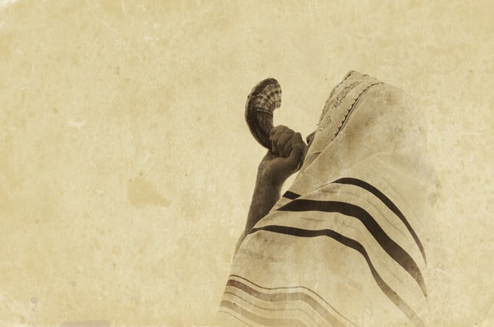 Jewish man blowing the Shofar (horn) 