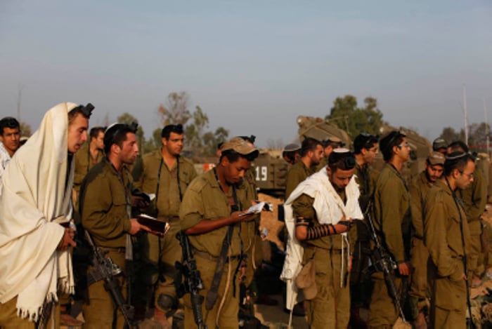 IDF soldiers at Shachris wearing Talleisim and Tefilin