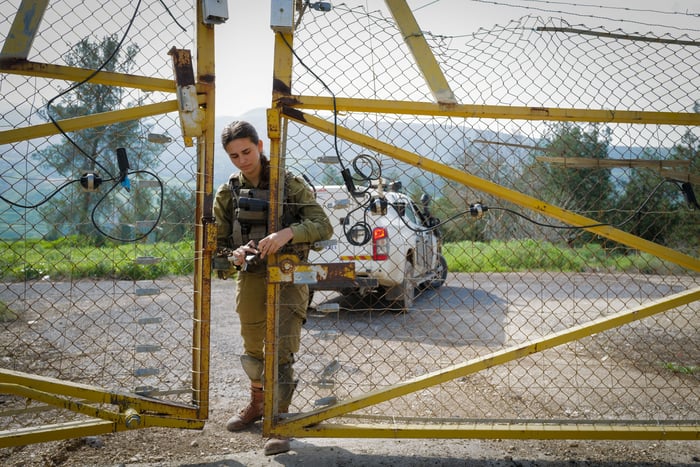 Israeli soldiers near the border fence at the tripoint border between Israel, Syria, and Jordan, northern Israel, on February 15, 2024