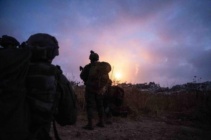 Soldiers silhouetted against the darkness.