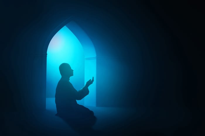 Muslim man praying in the mosque 