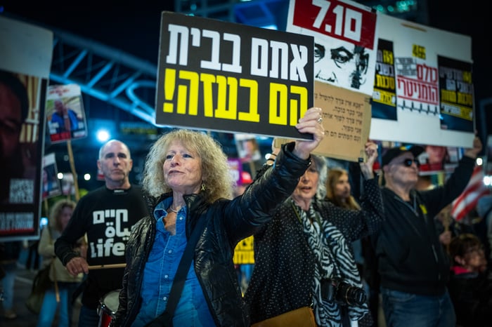 Demonstrators protest calling for the release of Israeli hostages held in the Gaza Strip outside Hakirya Base in Tel Aviv, January 14, 2025