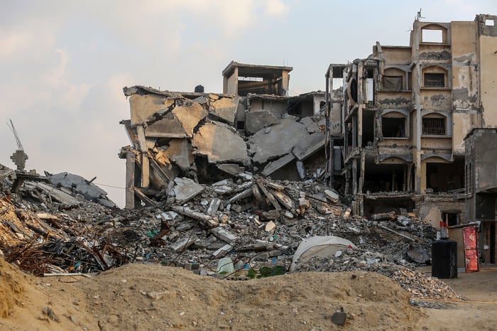 Palestinians seen around destroyed buildings from an Israeli Military operation, in Khan Yunis, in the southern Gaza Strip, January 11, 2025.