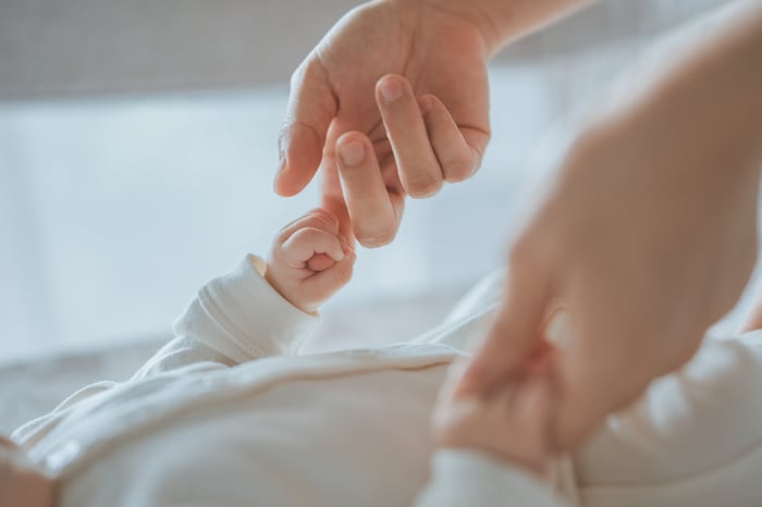 Close-up little hand of baby holding hand of mother