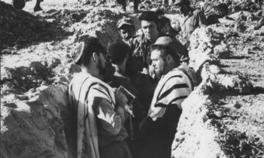 Soldiers praying in a ditch during the Yom Kippur War