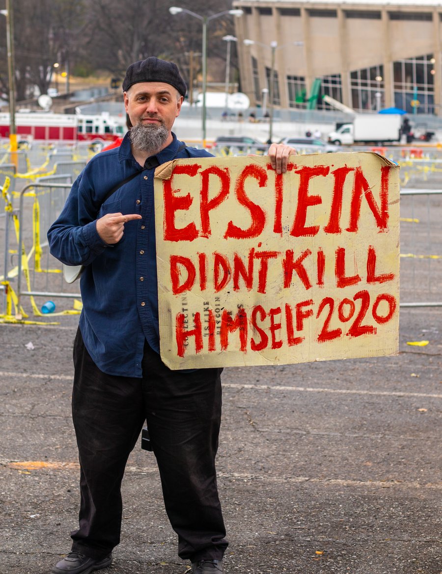 "Charlotte, NC / USA - March 2 2020: Man at Trump rally holding a sign that reads Epstein Didn't Kill Himself 2020" 