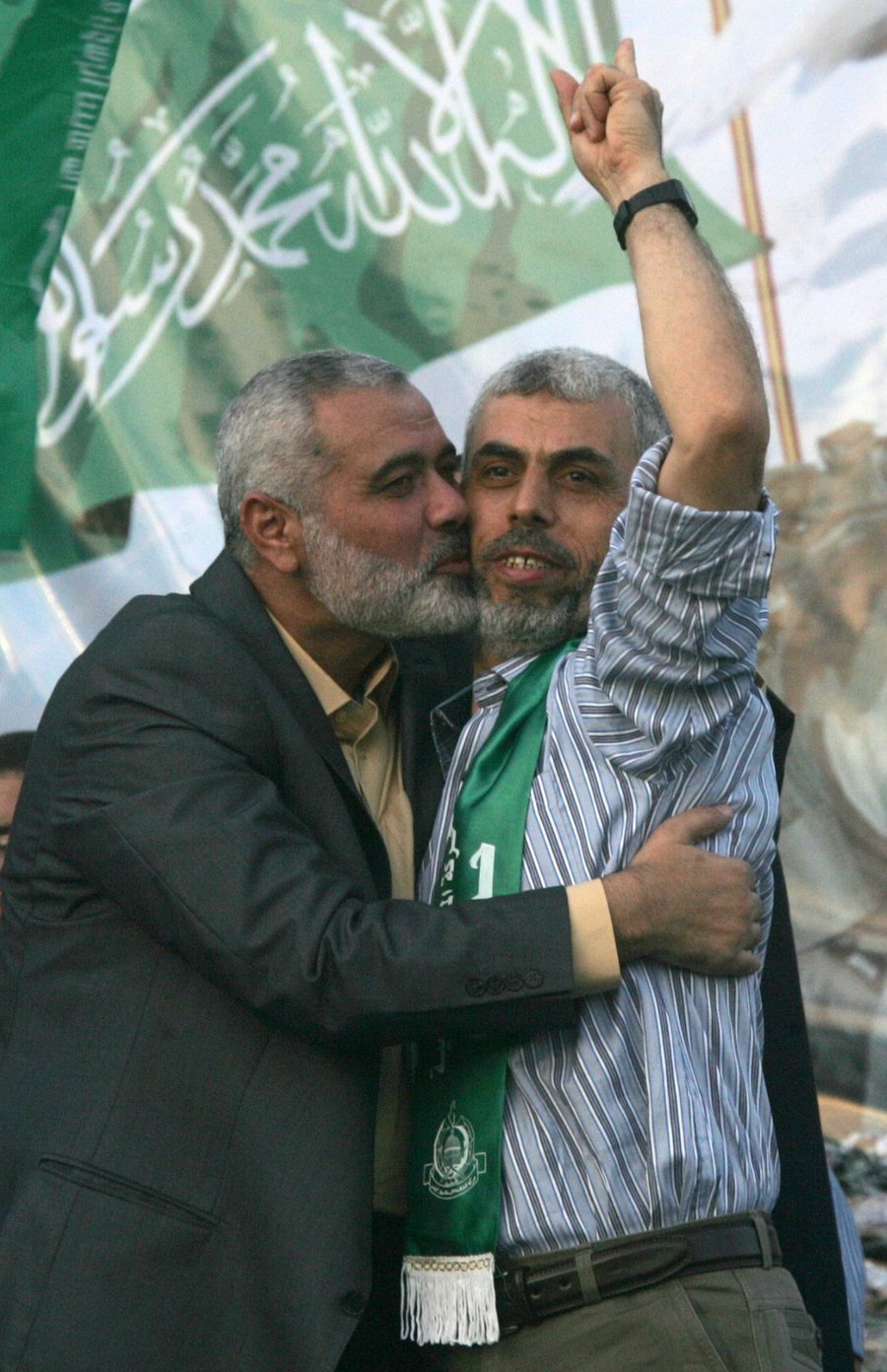 Hamas leader Ismail Haniya kisses freed Palestinian prisoner Yehiye Sinwar, a founder of Hamas' military wing, wave as Hamas supporters celebrate the release of hundreds of prisoners in the Shalit deal.