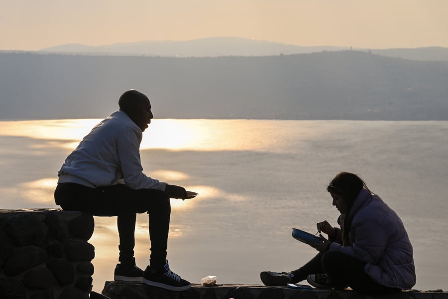Israelis enjoying the Sea of Galilee at sunset.