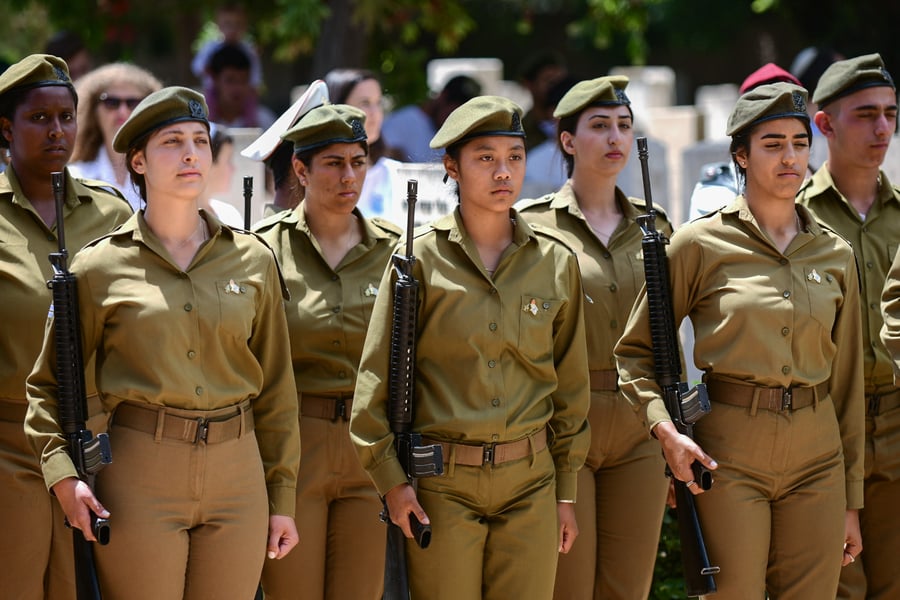 Female soldiers at attention during Memorial Day.