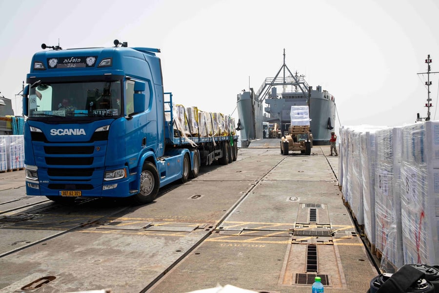 Trucks offloading aid from the US temporary pier off Gaza.