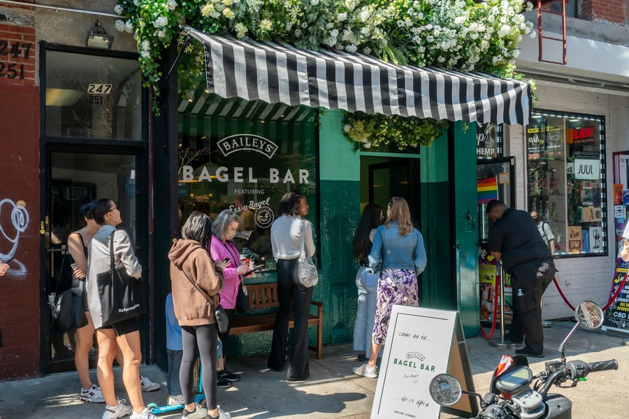 Participants wait in line outside Bagel store in New York.