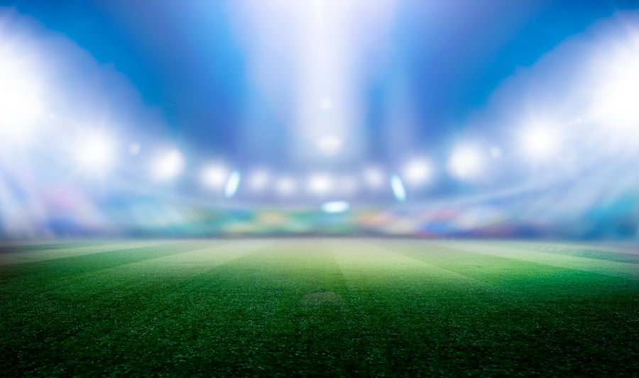 Football stadium with green grass with bokeh effect and spotlights