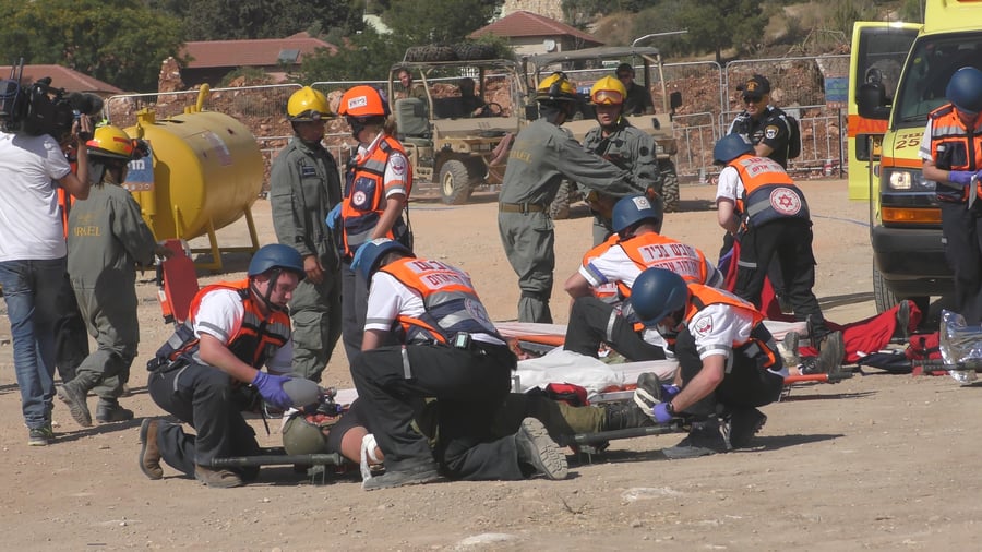 Paramedics and MDA staff deployed for rescuing injured people during a drill.