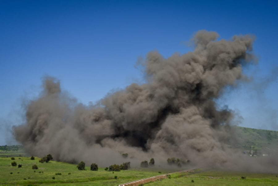 Smoke and fire rise from an explosion in northern Golan Heights, on the Syrian border