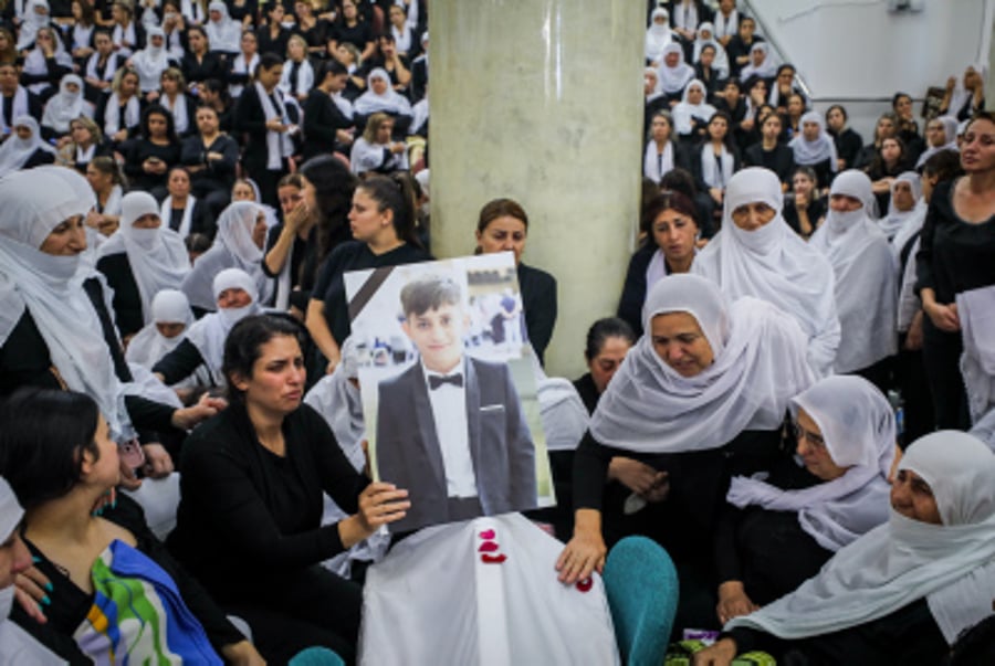 Family and friends mourn during the funeral service of druze children murdered by Hezbollah's rocket attack in Majdal Shams