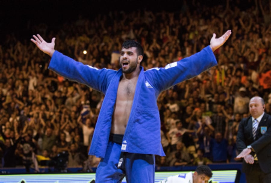 Israel's Sagi Muki raises his hands as he celebrates after winning 