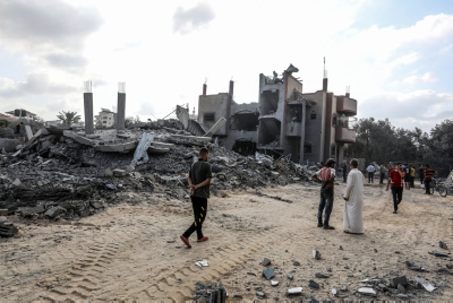 Palestinians inspect the damage to the home of the deputy secretary-general of the PFLP, Jamil Mazhar, in the Nuseirat refugee camp 