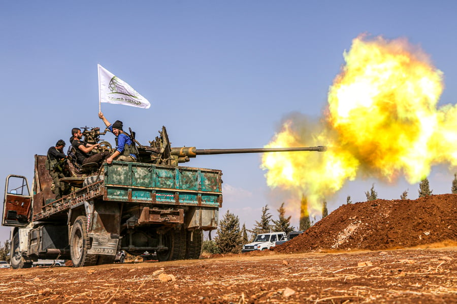 Military vehicles of the Syrian opposition fire on ISIS positions