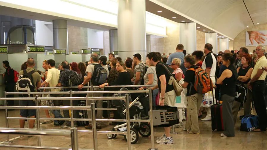 People wait in line at passport control at Ben Gurion International Airport 