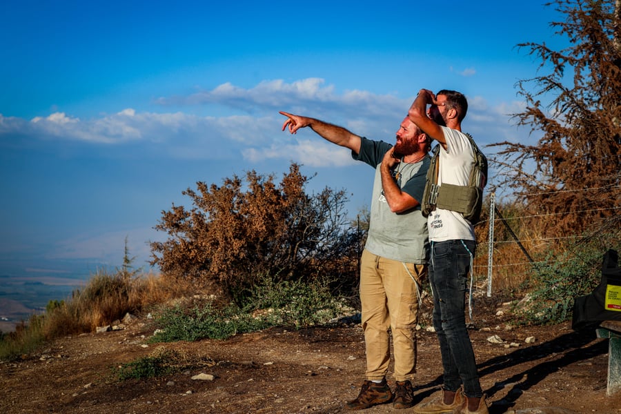 People watch Israeli air strikes in southern Lebanon, near the Israeli border with Lebanon, September 23, 2024.