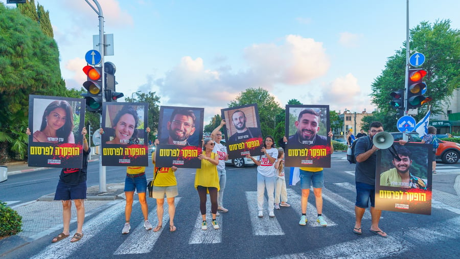 Haifa, Israel - September 01, 2024: People march in the street with posters of the 6 hostages who were murdered by Hamas in Gaza