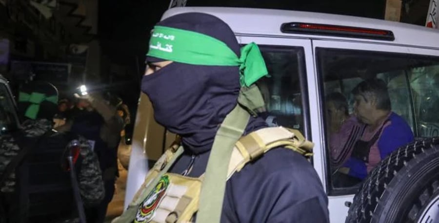 Hamas fighter next to a Red Cross vehicle 