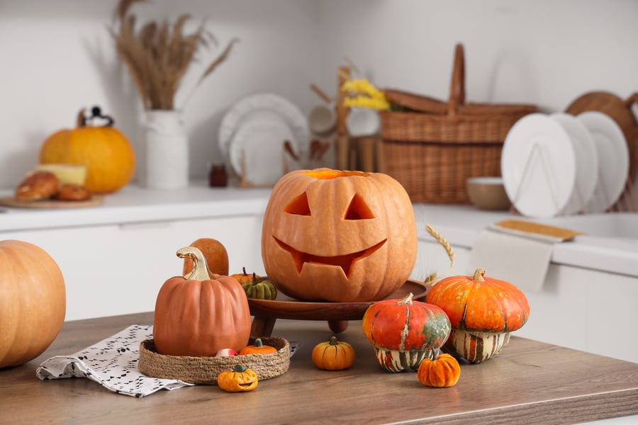 Halloween pumpkins on table in kitchen