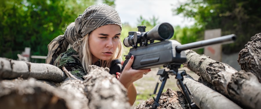 Female soldier shooting with sniper rifle