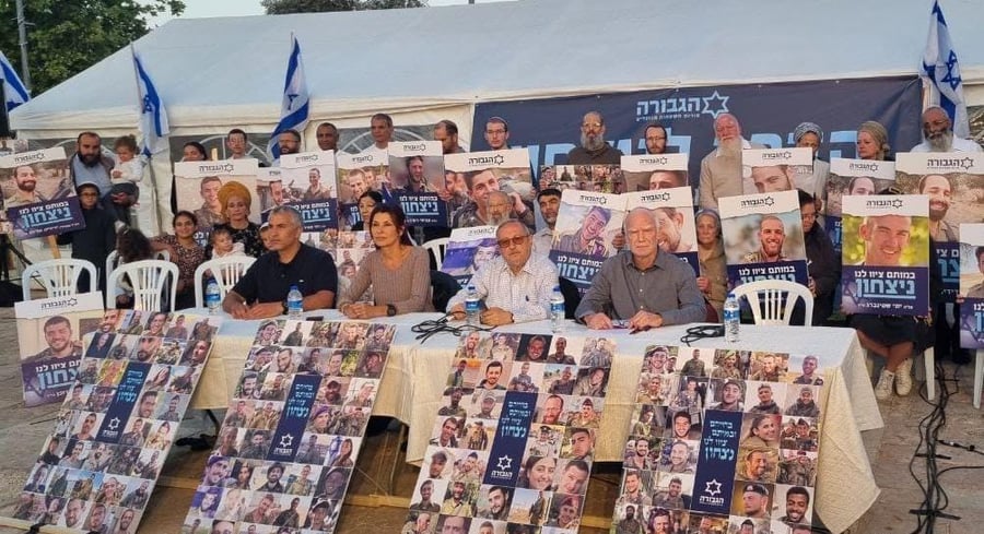 Rabbi Aharon Ankri, of blessed memory, with a photo of his brother-in-law, Yedidya Eliyahu, may his memory be a blessing. (Standing last on the left side)